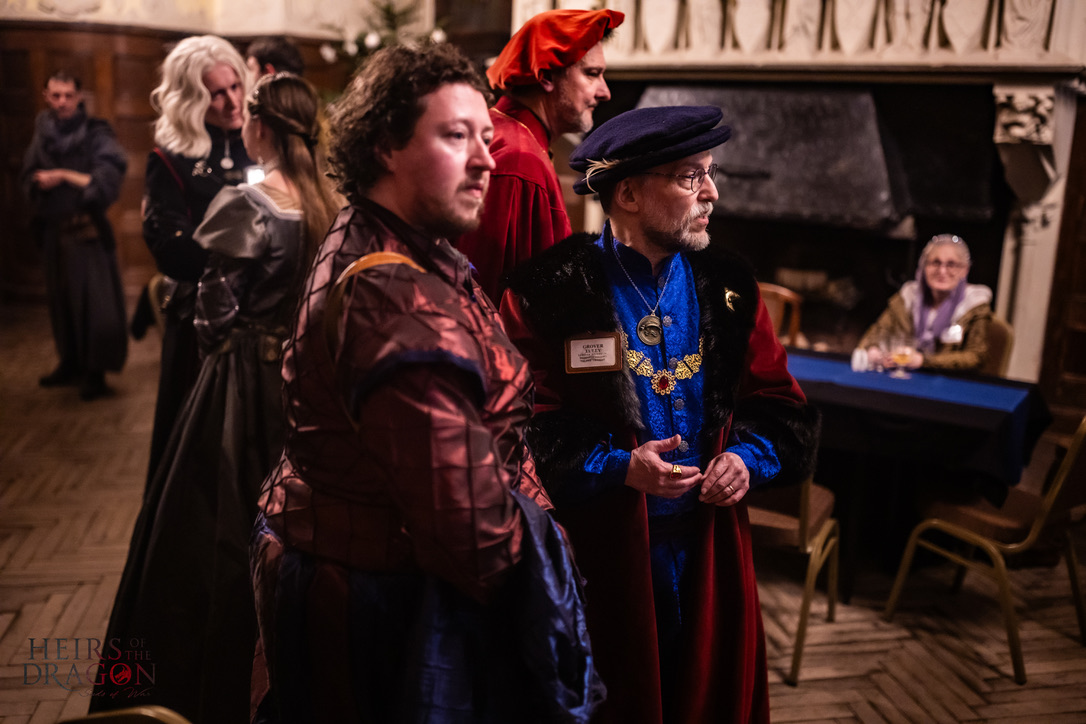 Lord Tully, Walter Tully, Daemon Targaryen, Lord Leffy, and others in the Great Hall of Harrenhal